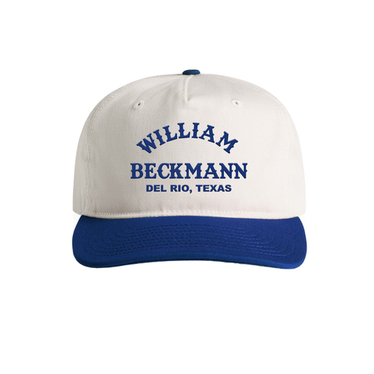 White cap with blue brim and embroidered text on a white background